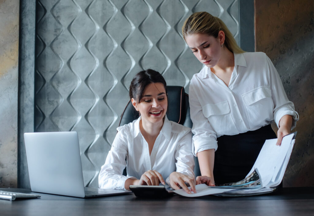 CPA for real estate businesses young-business-lady-female-director-sitting-office-desk-working-process-business-meeting-working-with-colleague-solving-business-tasks-office-collective-concept-1-scaled-1.jpg