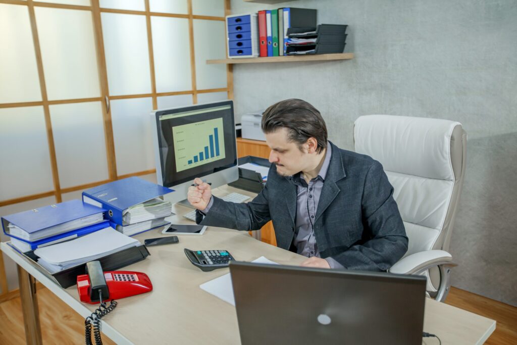 A young businessman working from his office - the concept of hard work and failure-Strategic Tax Planning for Real Estate Businesses- How to Reduce Your Tax Liability and Build Long-Term Wealth